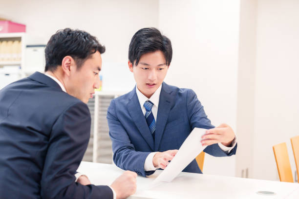 istock Businessman handling visitors at the counter 2196369530