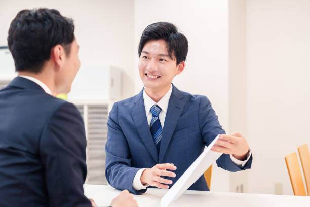 istock Businessman handling visitors at the counter 2196369534