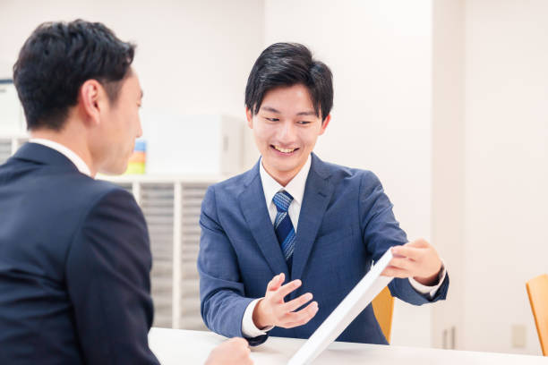 istock Businessman handling visitors at the counter 2196369546
