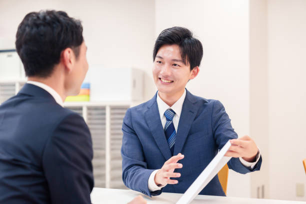 istock Businessman handling visitors at the counter 2196369547