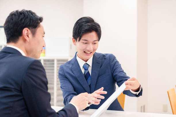 istock Businessman handling visitors at the counter 2196369560
