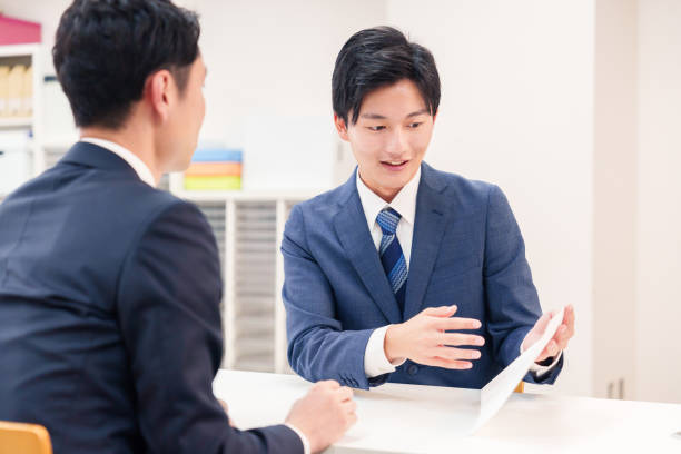 istock Businessman handling visitors at the counter 2196369582