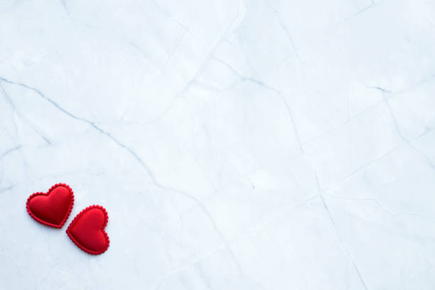istock Red hearths on corner of white marble background. Valentines Day banner. Space for text 2196371730