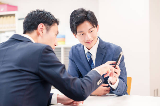 istock Two businessmen talking with their phones. 2196372062
