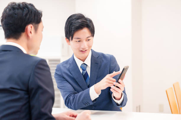 istock Two businessmen talking with their phones. 2196372065