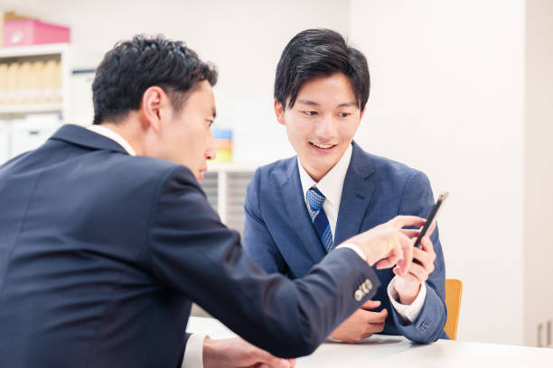 istock Two businessmen talking with their phones. 2196372070