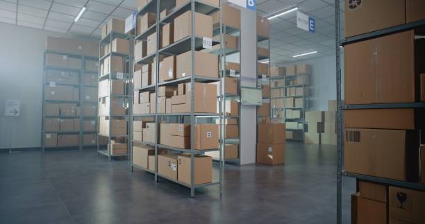 istock Warehouse Retail Center with Rows of Shelves with Cardboard Boxes and Parcels 2196372751
