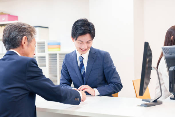 istock A man at the counter handling elderly visitors. 2196373789