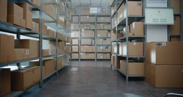 istock Warehouse Retail Center with Rows of Shelves with Cardboard Boxes and Parcels 2196374188