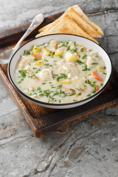 Chicken Pot Pie Soup is hearty, comforting and perfect for a busy weeknight meal closeup on the plate. Vertical