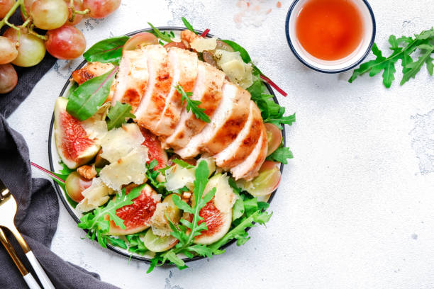 istock Delicious lunch with chicken, figs, cheese, grape and herbs. White background, top view 2196380812