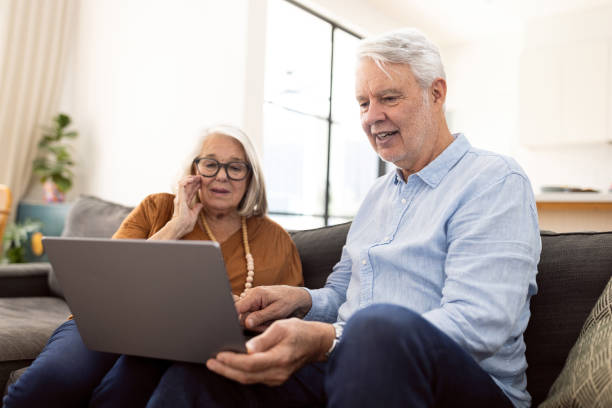 istock Senior Couple Browsing Online Together at Home on a Laptop 2196382331
