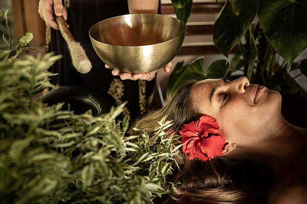 istock A woman relaxes during a singing bowl therapy 2196384155