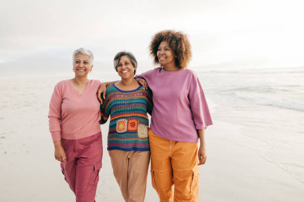 istock Women on the move: friendship and laughter by the ocean 2196386249