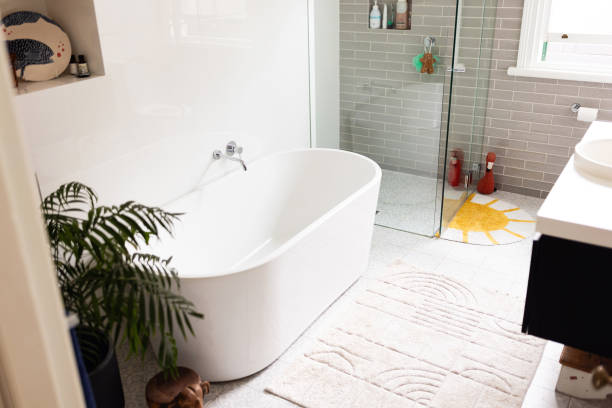 istock Modern Bathroom with Freestanding Tub, Glass Shower, and Decorative Elements 2196386999
