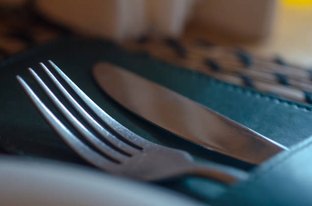 The End: Knife and Fork on Dirty Plate Close-Up