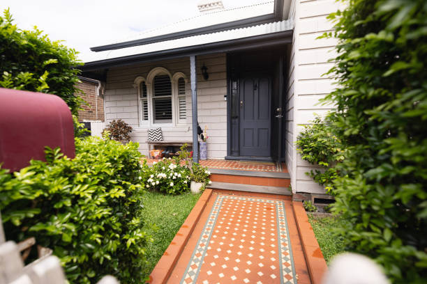 Cozy Residential House Front Yard with Vintage Tiled Pathway and Lush Greenery