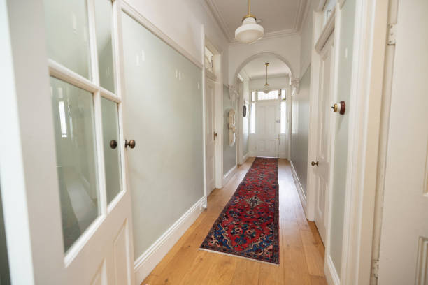 istock Bright Hallway Interior with Wooden Flooring and Traditional Decorative Rug 2196388341