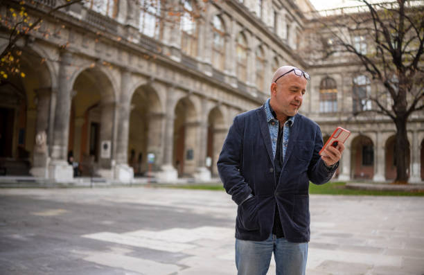 istock Experienced University Lecturer Using Smartphone Outdoors 2196388728