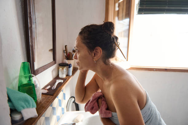 istock Woman Reflecting in Bathroom Mirror During Her Morning Routine 2196389274