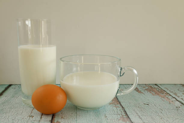 istock Eggs and milk on rustic wooden table, photographed from a side view. 2196390270