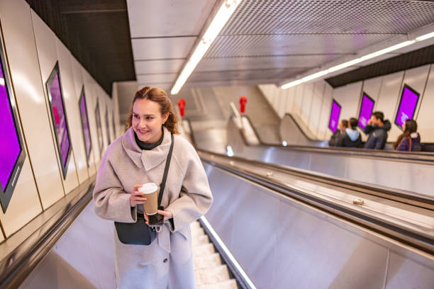 istock Riding the Subway Escalator with a Coffee in Hand 2196390363