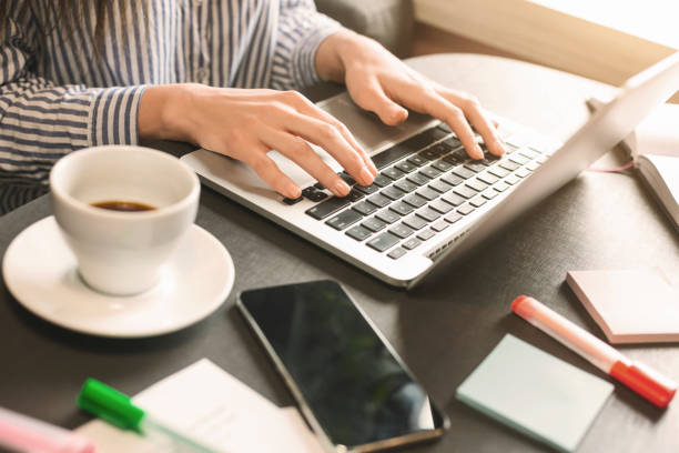 istock Female blogger typing on laptop in cafe 2196392043