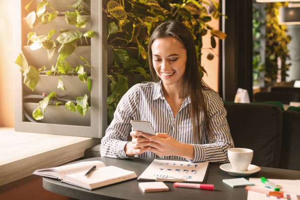 istock Happy millennial woman chatting on cellphone in cafe 2196392046
