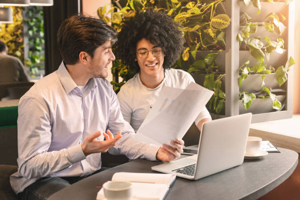 istock Two handsome businessmen in cafe discussing important project 2196392055