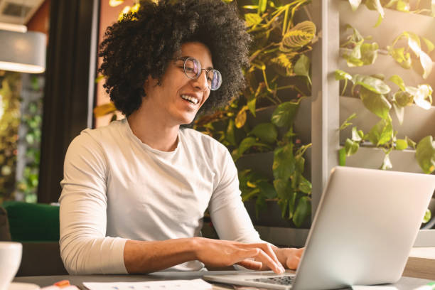 istock Young black businessman working on his laptop in cafe 2196392060