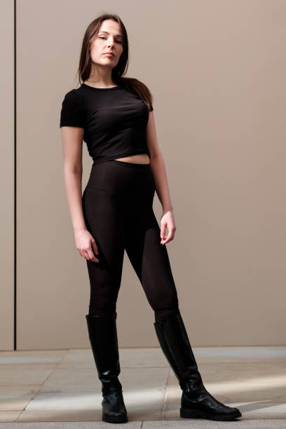 istock Fashion model posing in black outfit and boots 2196392452