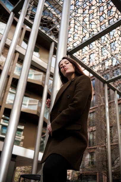istock Businesswoman posing under modern metal structure 2196392455