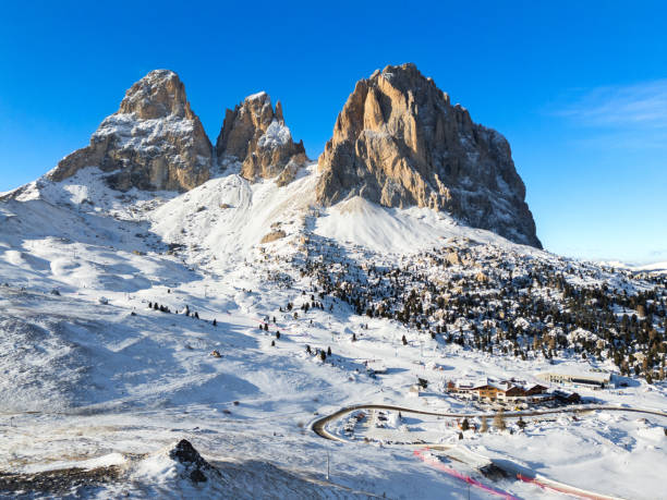 Drone view of Passo Sella, Dolomites Alps with snow, Langkofel, Sassolungo