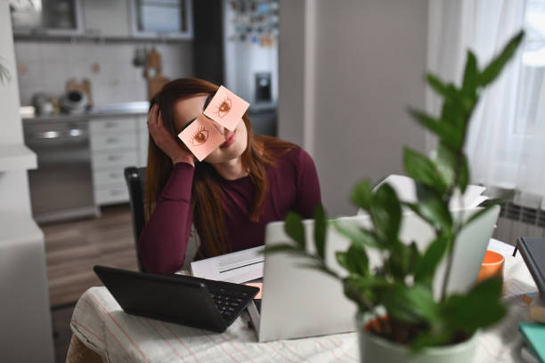 istock Female Leaning on Head on Hand Pretending Not to Sleep During Boring Online Class 2196393512