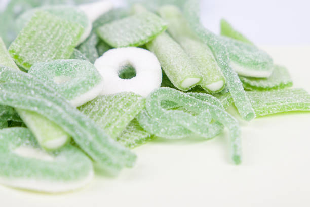 Green, blue, red, orange, brown chocolate candies in store, full frame.