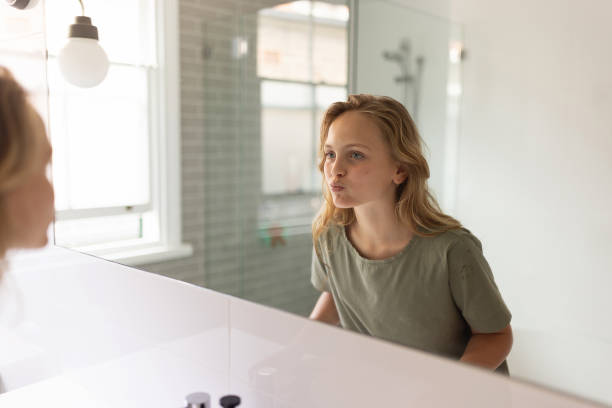istock Young Woman Engages in Morning Routine in Modern Minimalist Bathroom Setting 2196394642