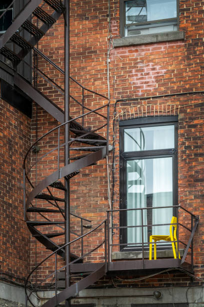 Rusty metallic outside spiral stairs on a brick building in Montreal, Canada