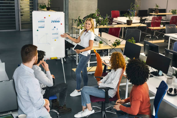 Team Member Presents Project Updates in Modern Office Setting During Afternoon Meeting