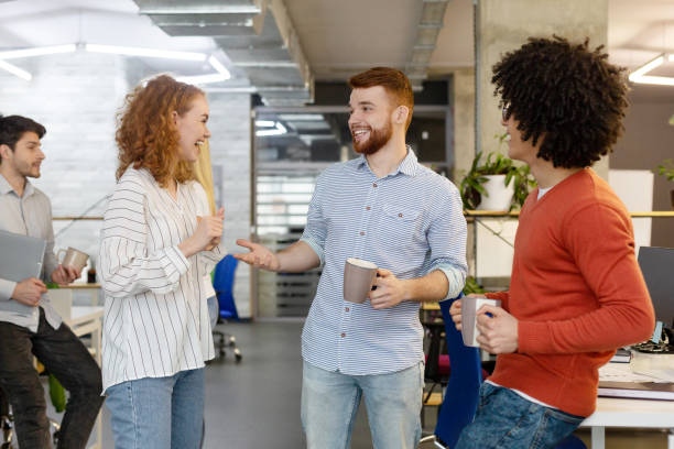 istock Cheerful colleagues enjoying coffee break in office 2196397338