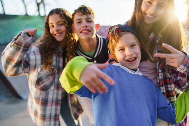 istock Happy children during a sunny day in a skateboard park 2196398232