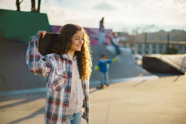istock Girl holding skateboard in skateboard park 2196399367