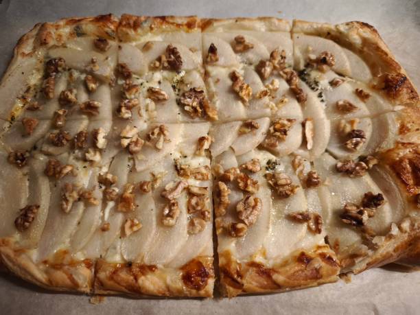 istock Rustic pear tart featuring golden pastry, crumbled blue cheese, and toasted walnuts garnishing buttery, caramelized surface easy dinner for Valentines day 2196401345