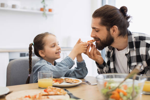 istock Caucasian family enjoying pizza breakfast together in cozy home setting 2196402015