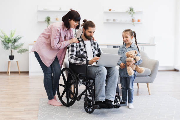 istock Family together in modern kitchen supporting father with disability 2196402030