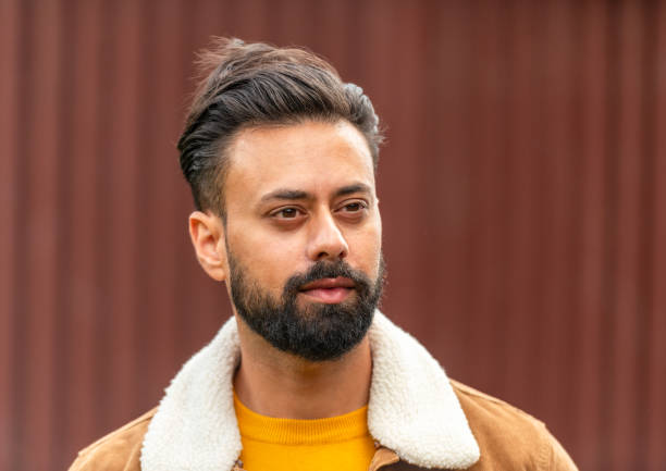 Relaxed outdoor head and shoulders portrait of a man in his thirties in London, England.