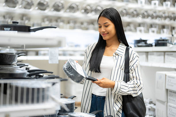 istock Young woman shopping for kitchen cookware in store 2196402864