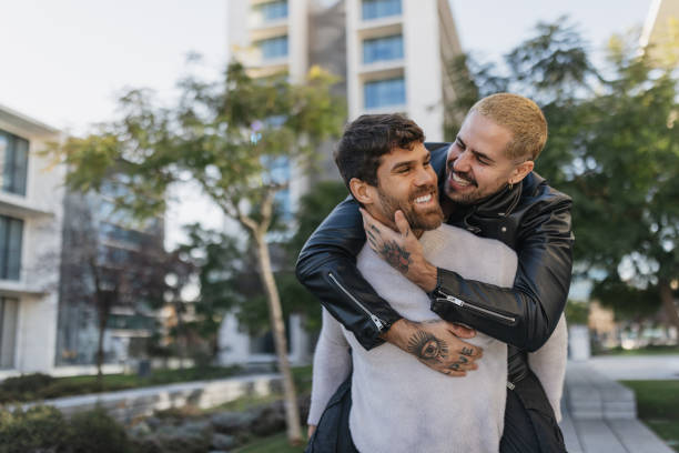istock Playful hug between friends in vibrant environment 2196403651
