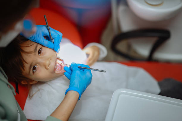 istock Young child girl check out teeth at dentist office 2196407975