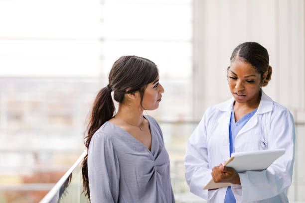 istock Doctor and Patient Discussing Medical Issues in Clinic 2196411345
