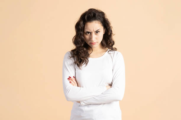 istock Serious woman with crossed hands studio portrait 2196411876